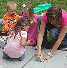 children and teacher outside Uintah Basin Child Development Lab