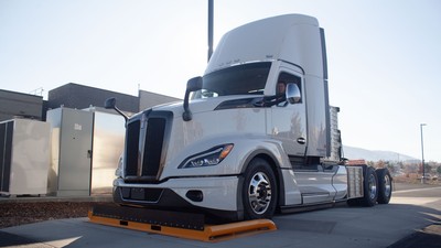 An electric semi tractor parked on a charging pad.