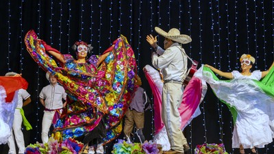 Latino singers and dancers on stage.