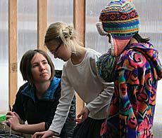 after school teacher Alanna Nafziger working with students in the greenhouse