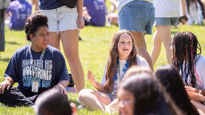 Students gather on a lawn