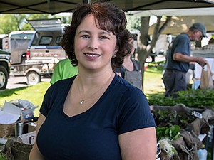 Kynda Curtis at an outdoor market with locallly produced produce