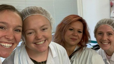 USU food science student Josie Sorensen with fellow students in the lab.