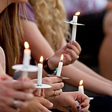 students with candles as part of college activity
