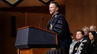 Brad Mortensen stands at a podium giving an address at his inauguration