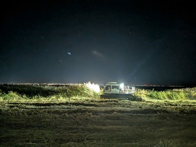 A machine in a field at night.