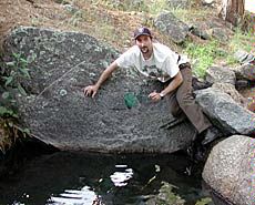 USU alum Chris Feldman at small stream hunting snakes