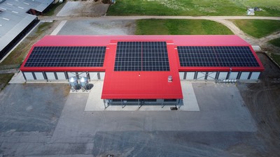 Solar panels on the roof of an agricultural building.
