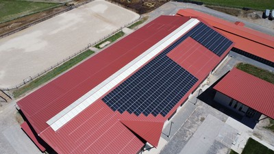 Solar panels on the roof of an agricultural building.