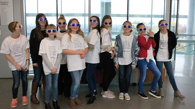 Sunglasses wearing elementary school students lined up in Huntsman Hall.