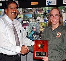 Kate Stephens accepting award from Juan Palma, Utah BLM director