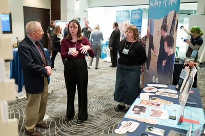 People talking at a research event.