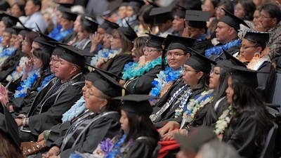 Students at USU Blanding in cap and gown for commencement ceremony.