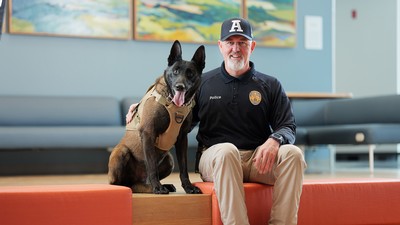 K9 handler Detective Mitch Blackham sits with new K9 officer Wolverine