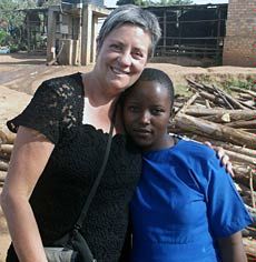 USU professor Sonia Manuel-DuPont and young girl at orphanage in Uganda