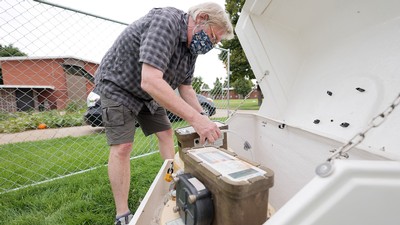 Professor Ryan Dupont sets up waste water collection apparatus