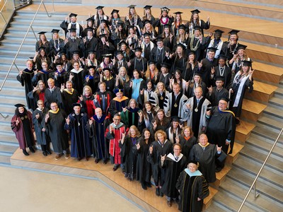 A group of students and administrators pose for an aerial group photo.