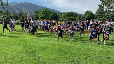 A group of people run in a 5K race