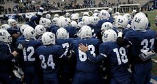 Aggie football players on the field