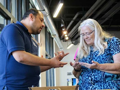 A USU food science student teaching a guest