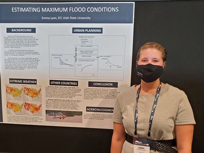 Emma Lyon stands with her poster at the Association of State Dam Safety Officials in Nashville.