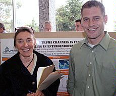 Symposium coordinator Anne Anderson with USU student Doug Holt 