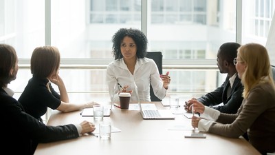 woman leading a meeting in a conference room.