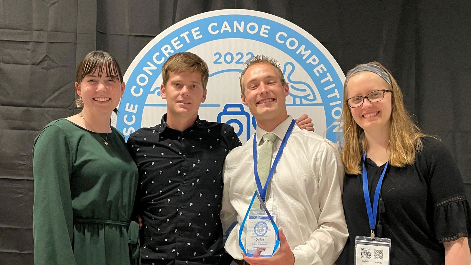 USU Engineering students pose for a photo with a concrete canoe trophy.