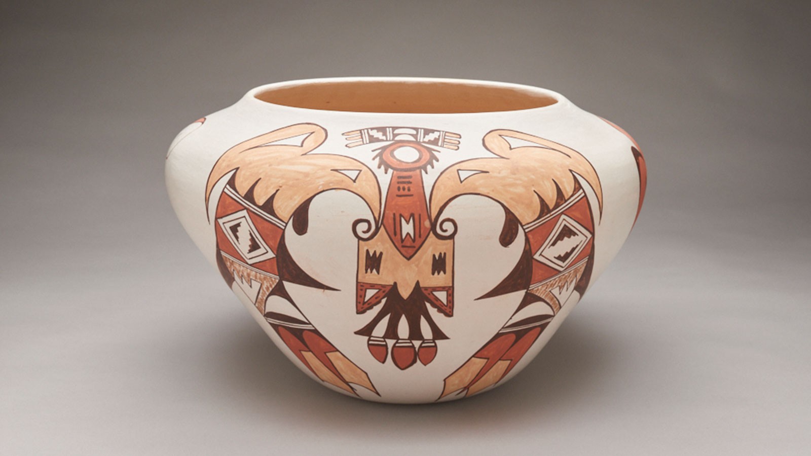 A pottery bowl with a Native American bird design.