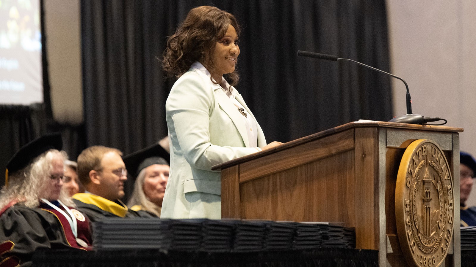 Kosi Colin speaks from the podium.