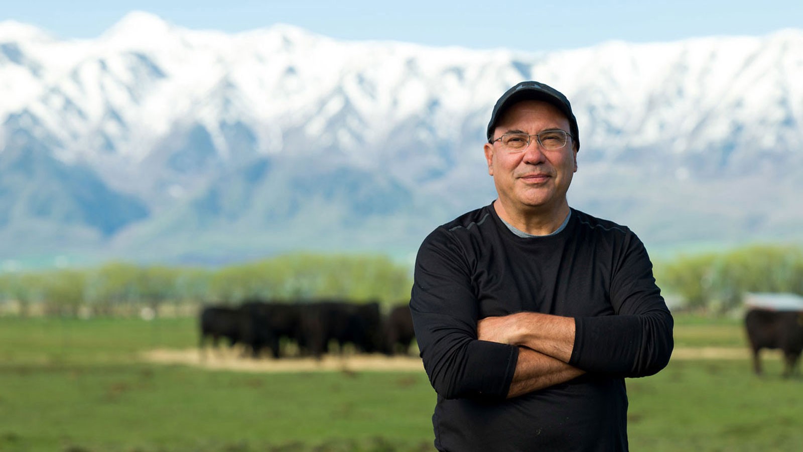 Juan Villalba poses for a portrait photograph in a Cache Valley cow pasture.