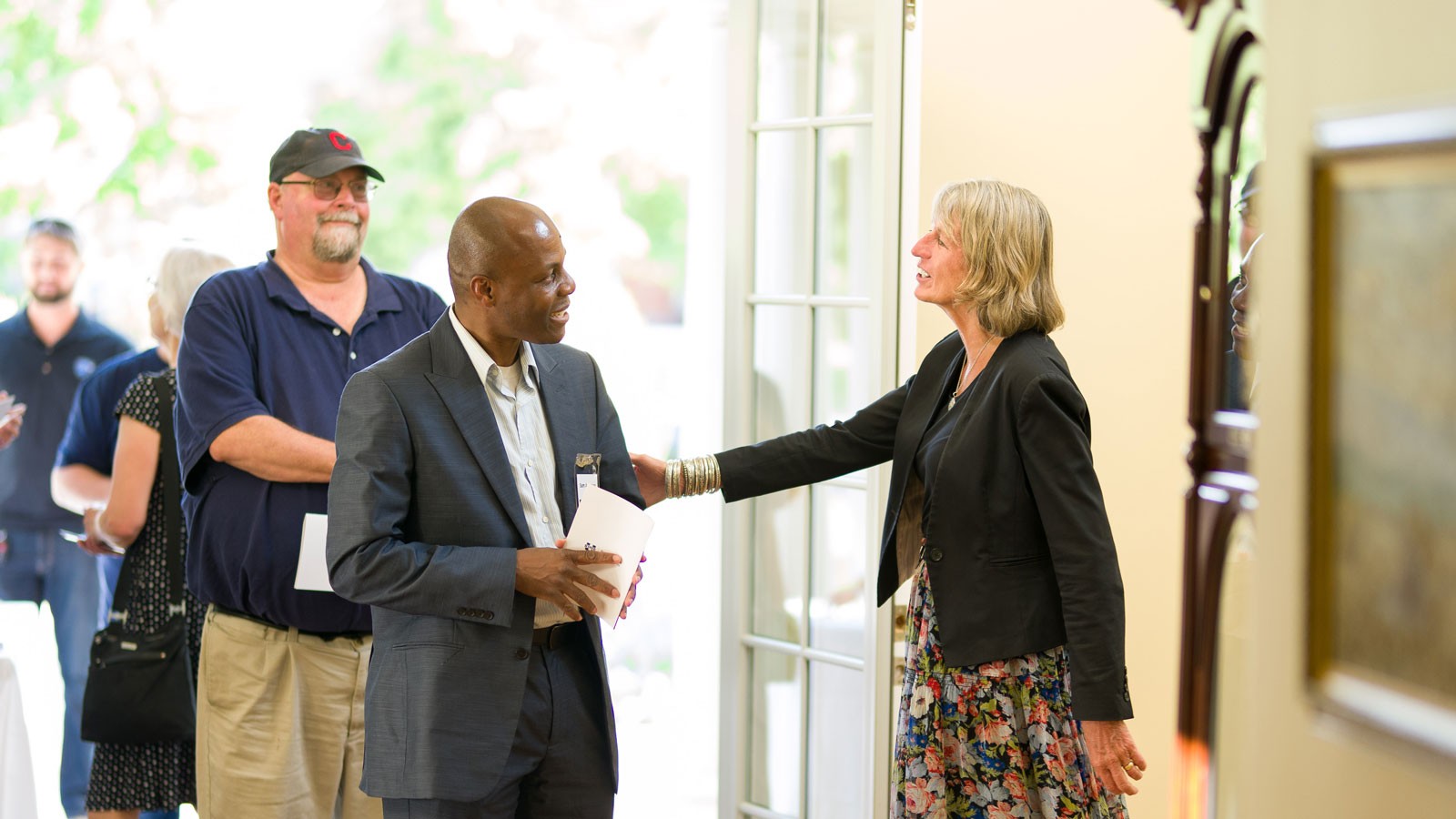People greeting each other at an event.