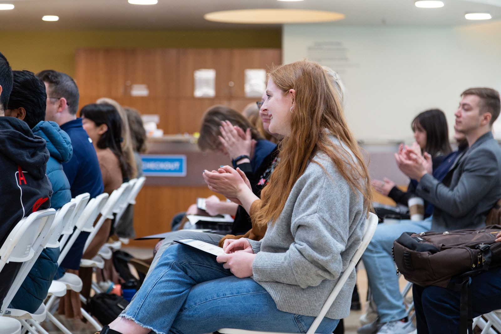 Attendees clapping at the Student Research Awards.