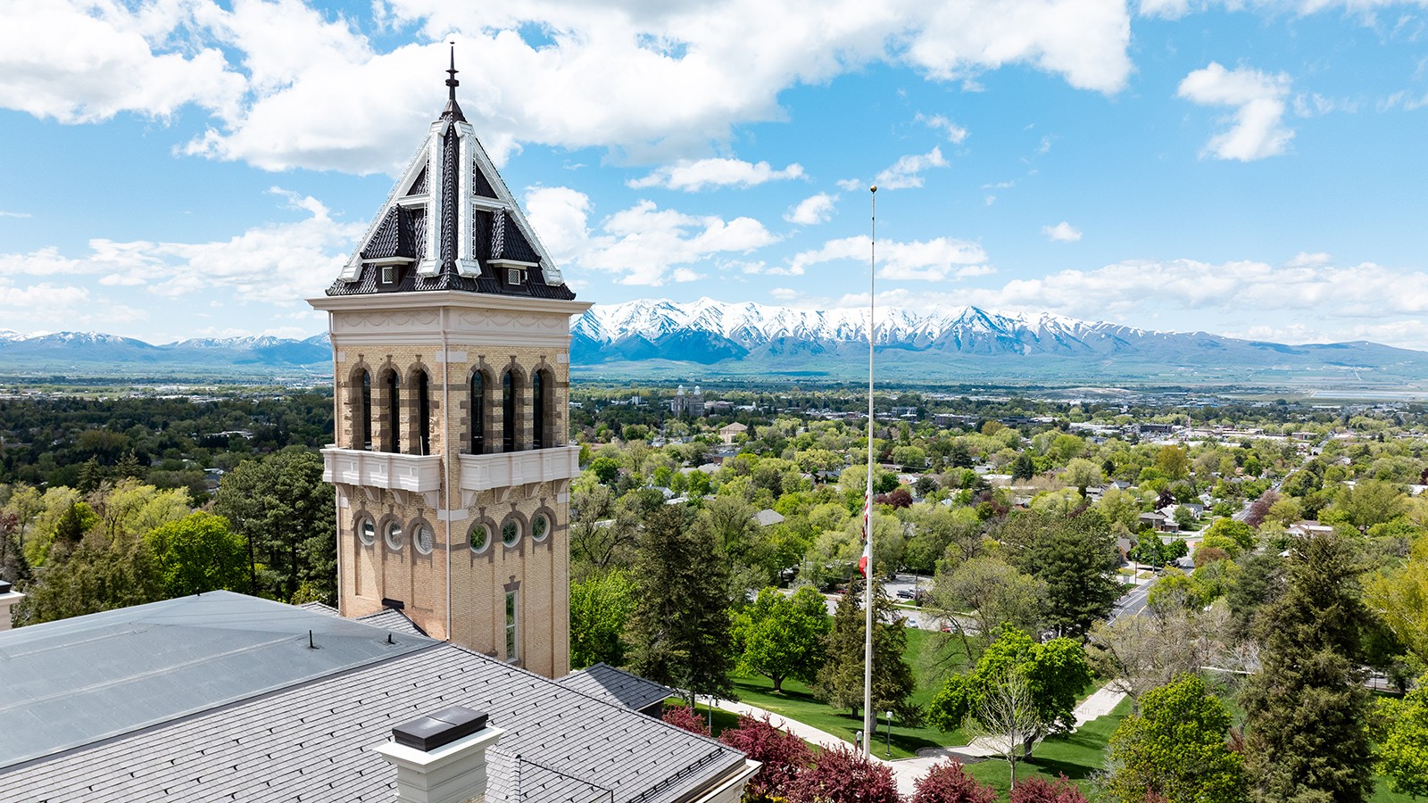A drone shot of USU campus showing the landscape from a distance.