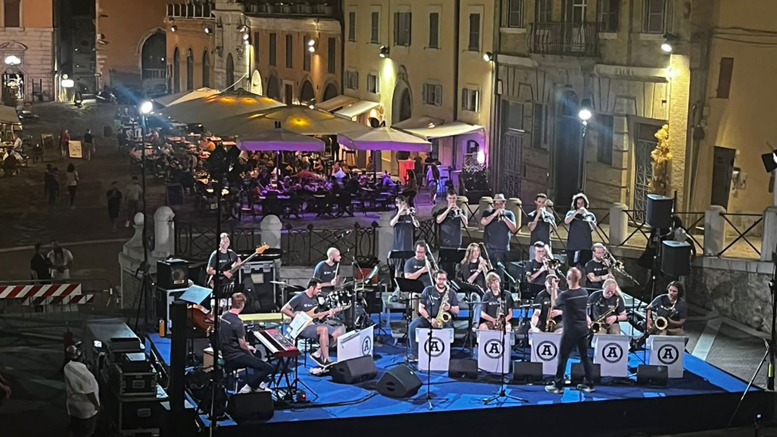 A jazz orchestra performing at a street venue in Italy.
