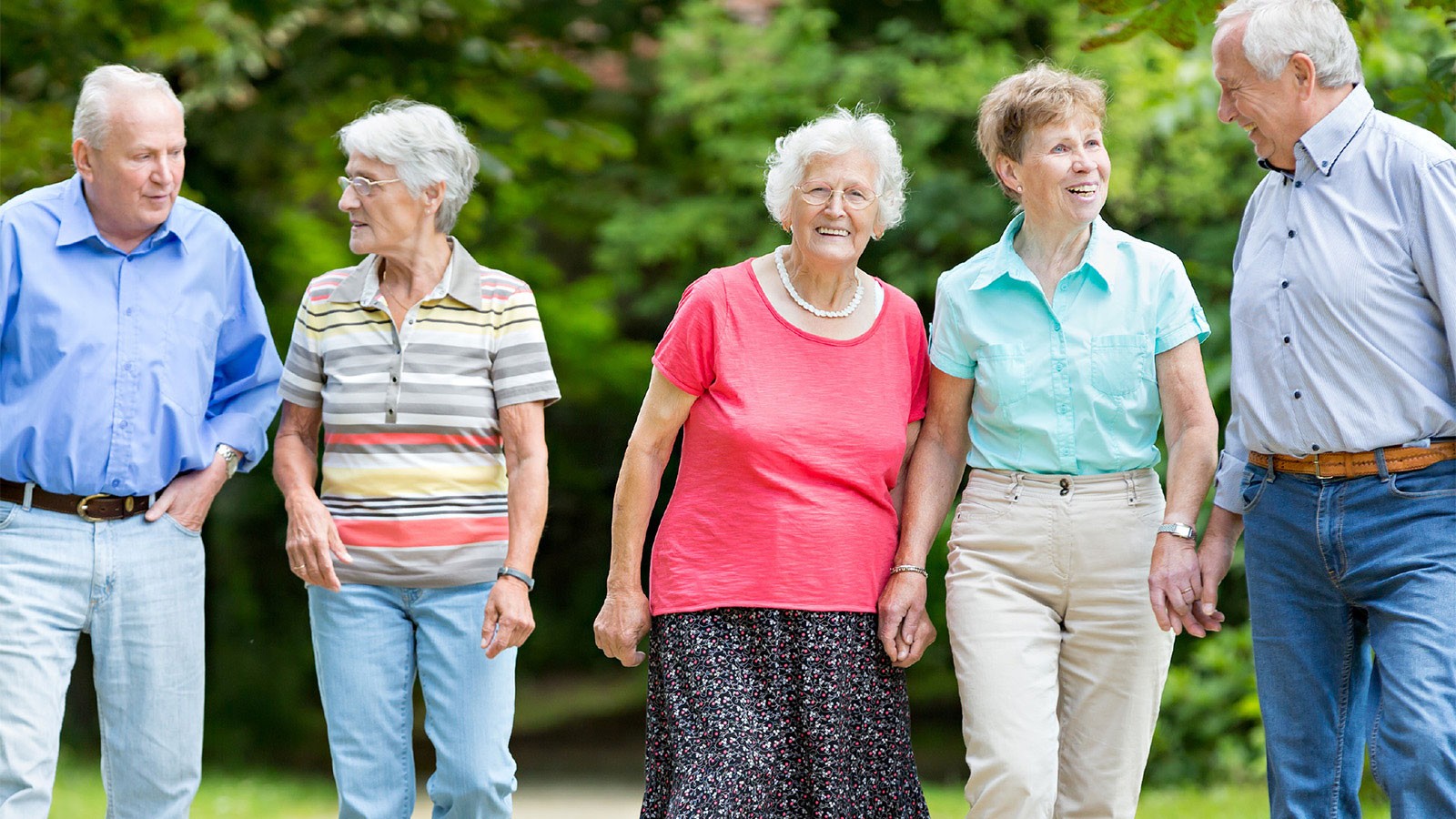 Older people walking along a path.