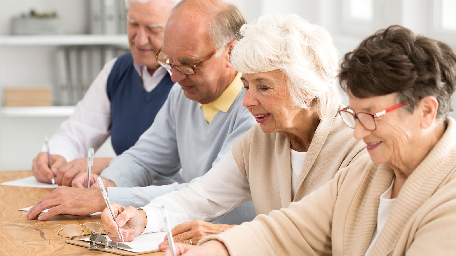 Older people filling out documents.