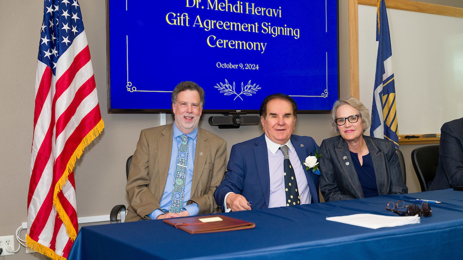 Joseph Ward, Medhi Heravi and Elizabeth Cantwell at a ceremony.