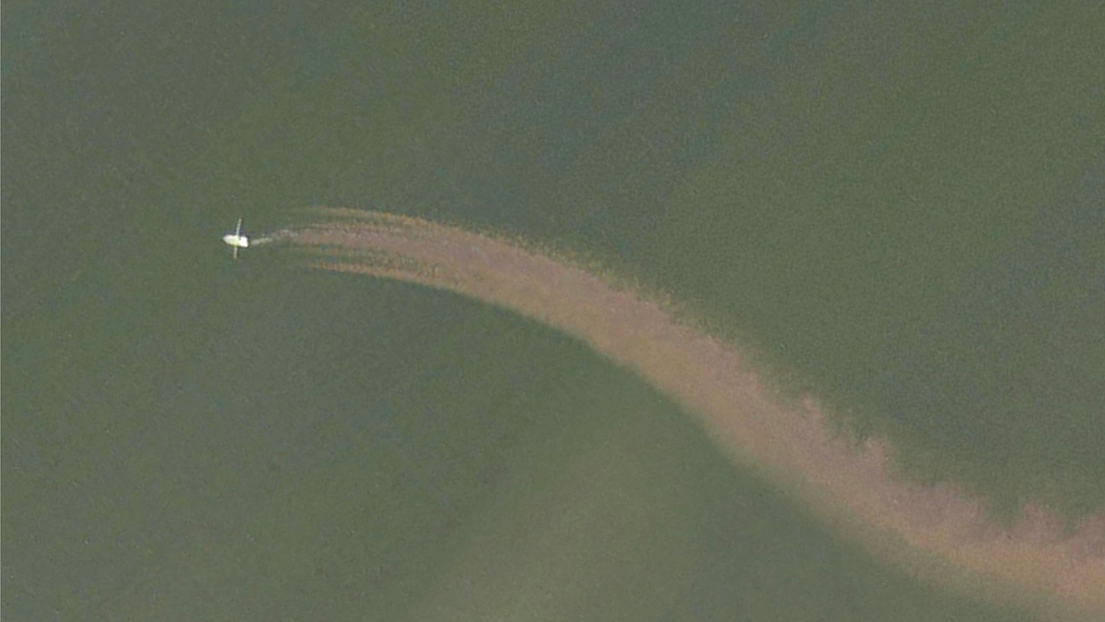 A satellite image showing a twin-rigged shrimp trawler in the northern Gulf of Mexico raising a plume of sediment off the seafloor.