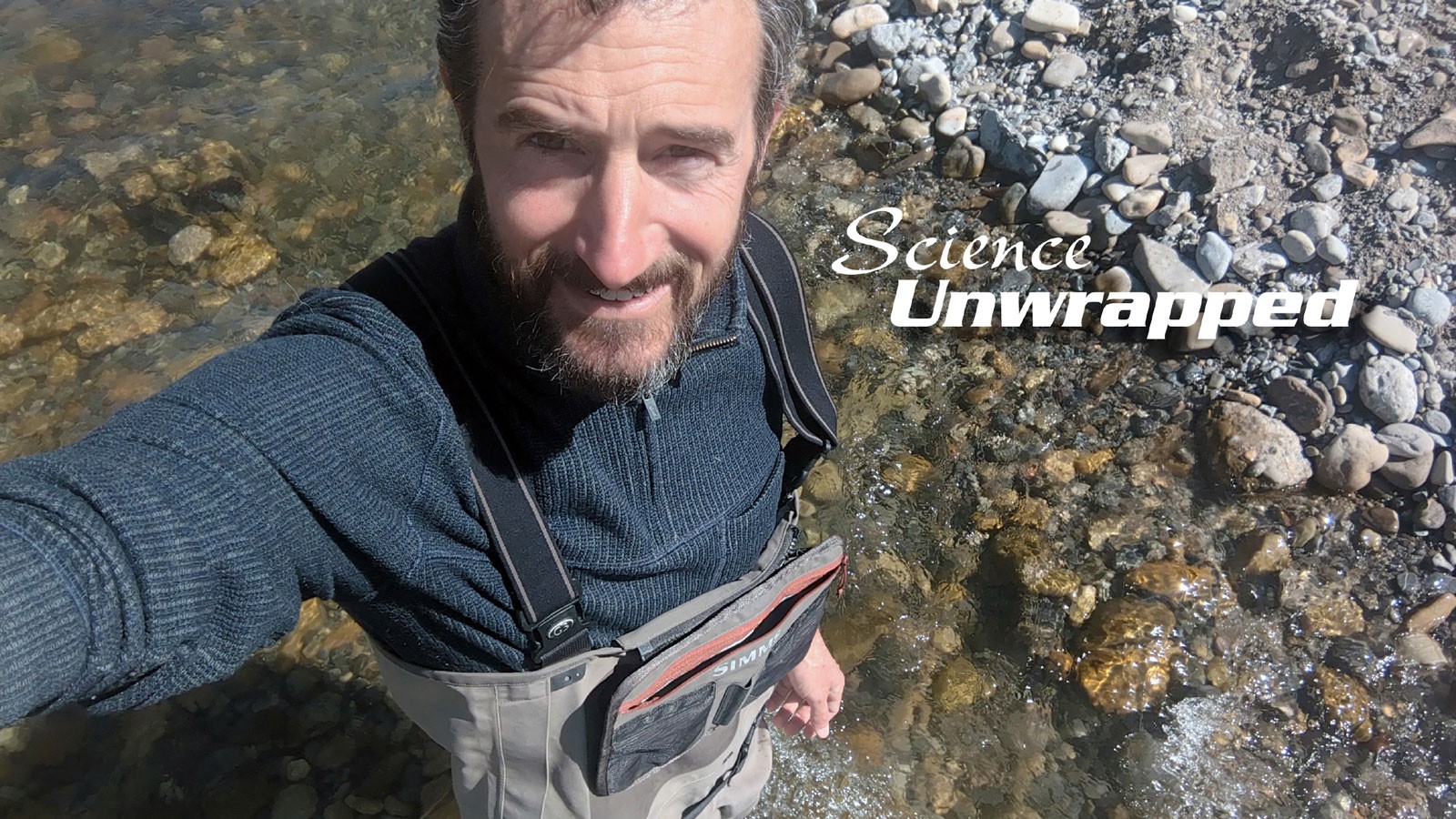 Patrick Belmont wading in a stream.