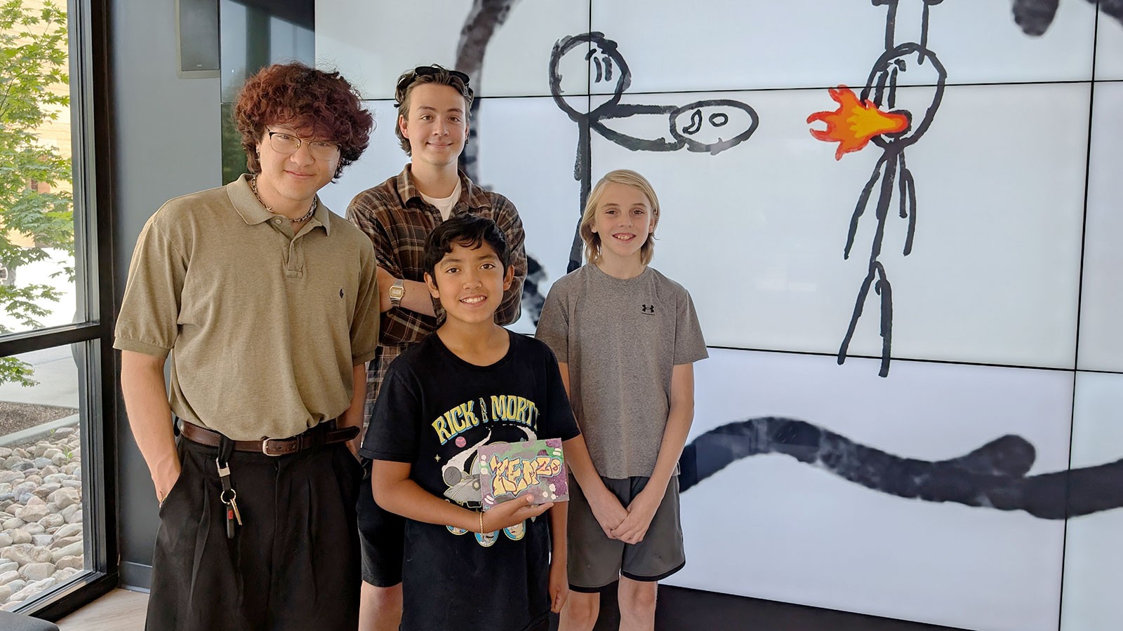 People posing with art projects.