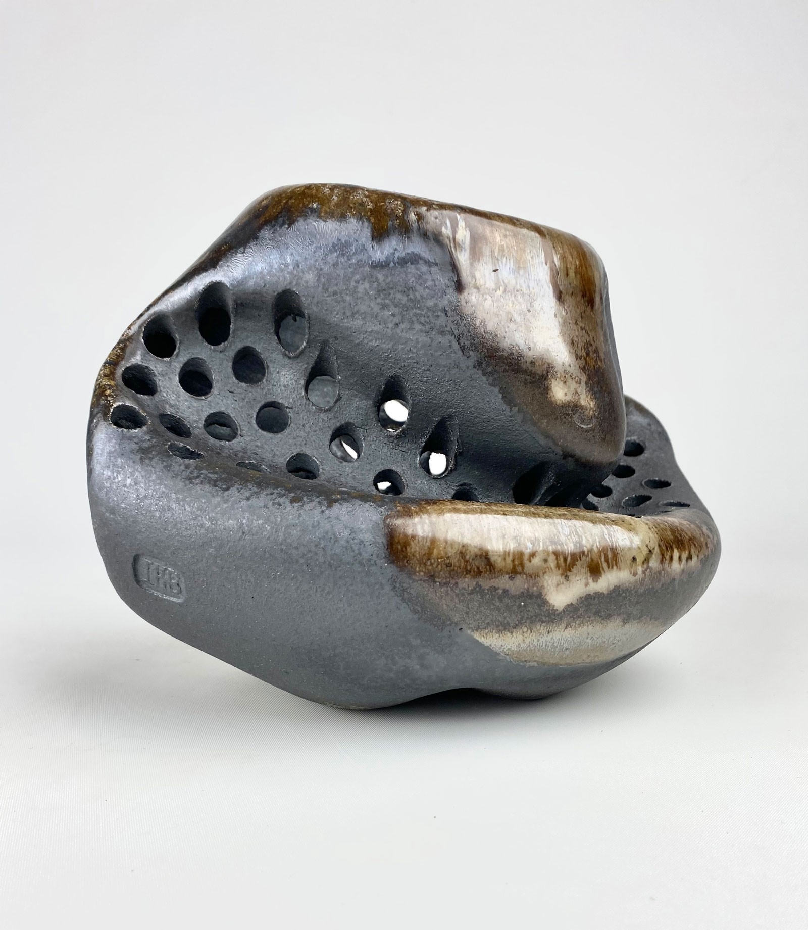 A ceramic sculpture with an abstract shape.
