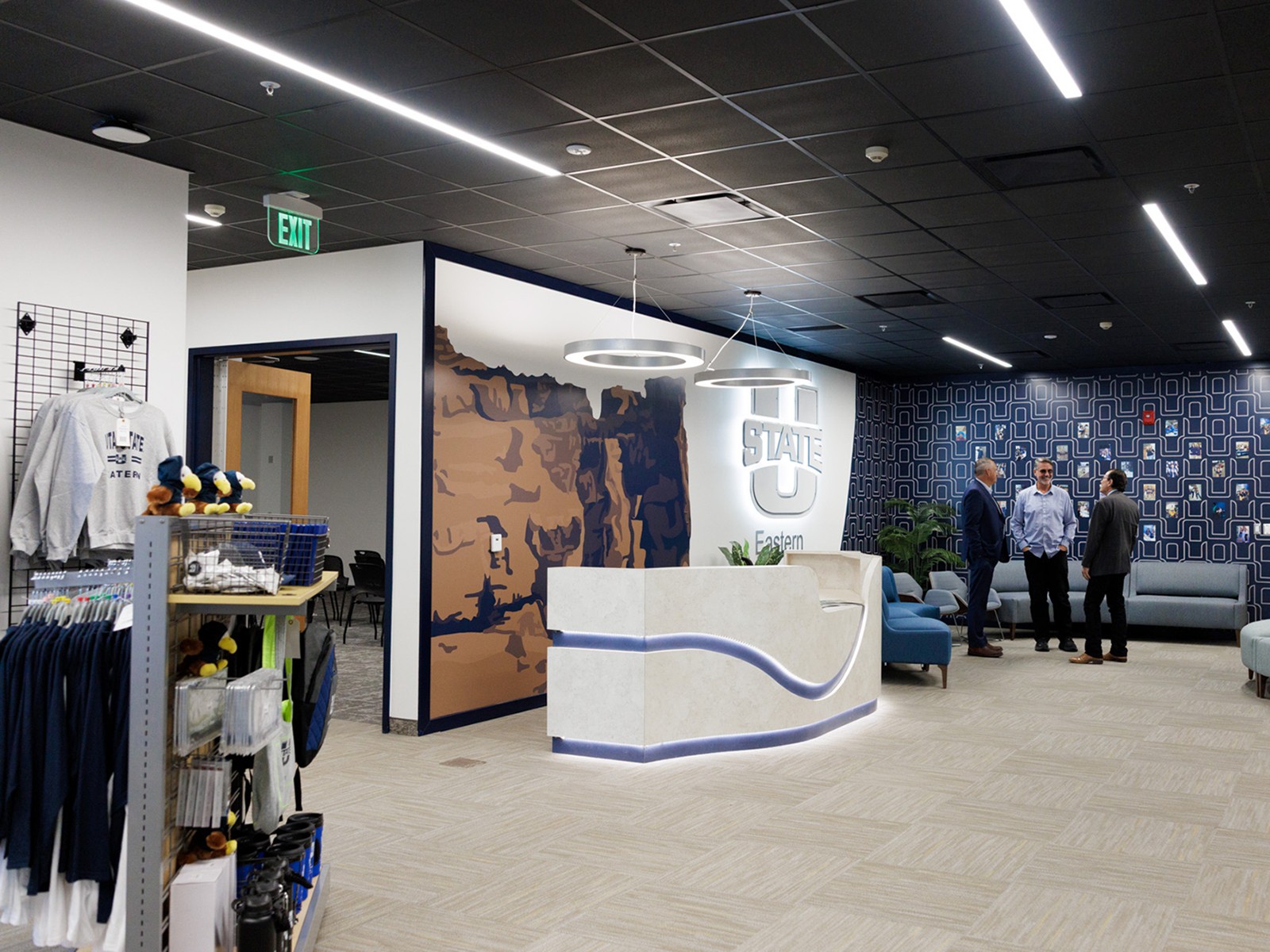 A desk, kiosk with merchandise and a logo of Utah State Eastern.