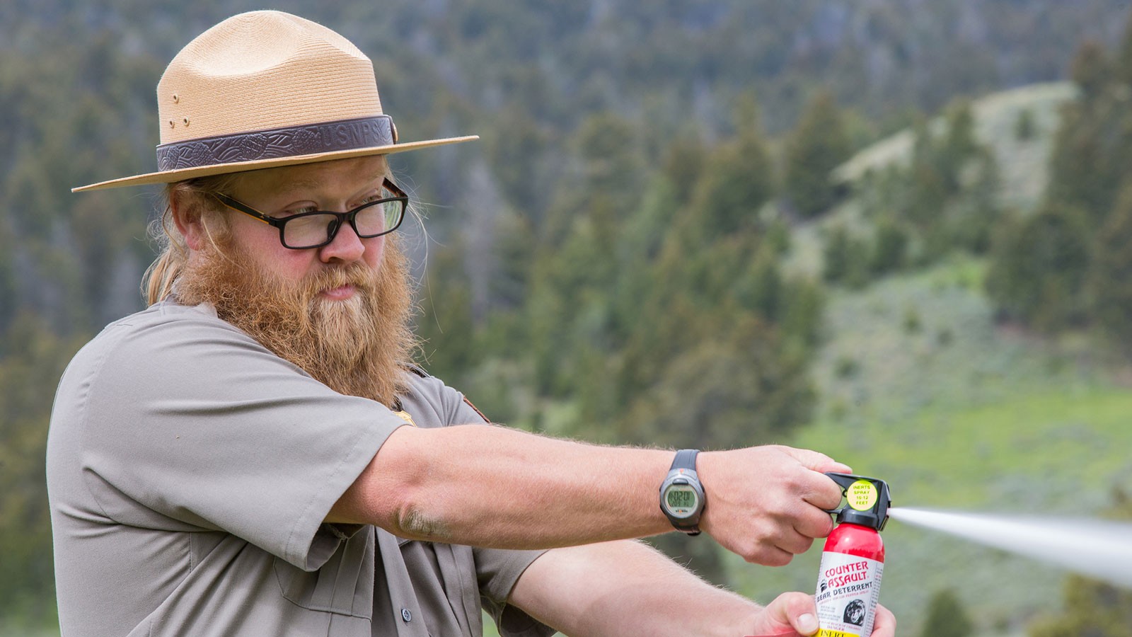 A ranger demonstrating the use of bear spray.