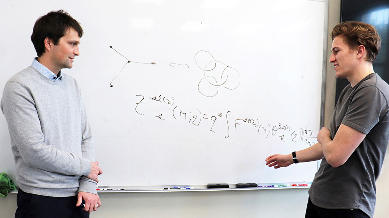 USU mathematicians at a whiteboard.