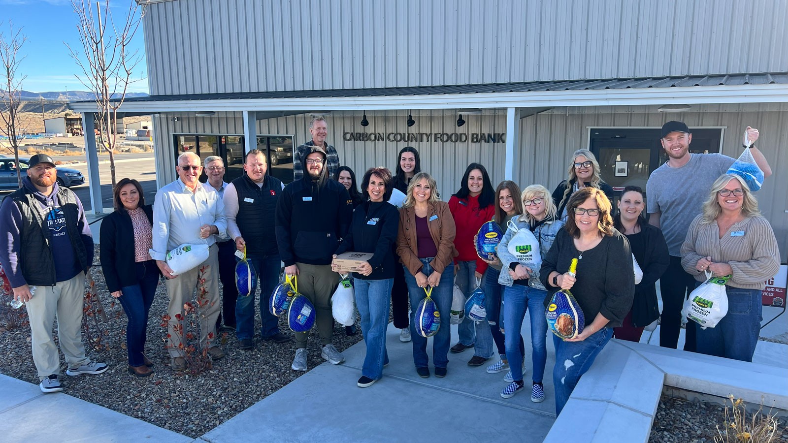 Volunteers posing for a group photo outside the Carbon County Food Bank.