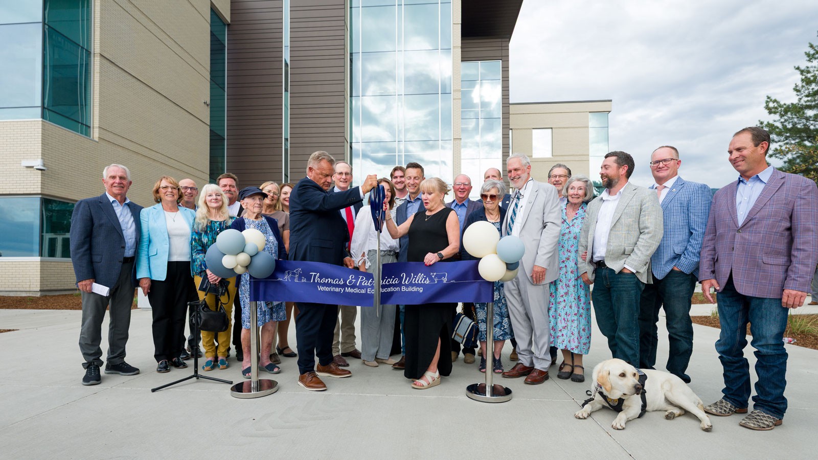 A crowd of people at a ribbon-cutting ceremony.