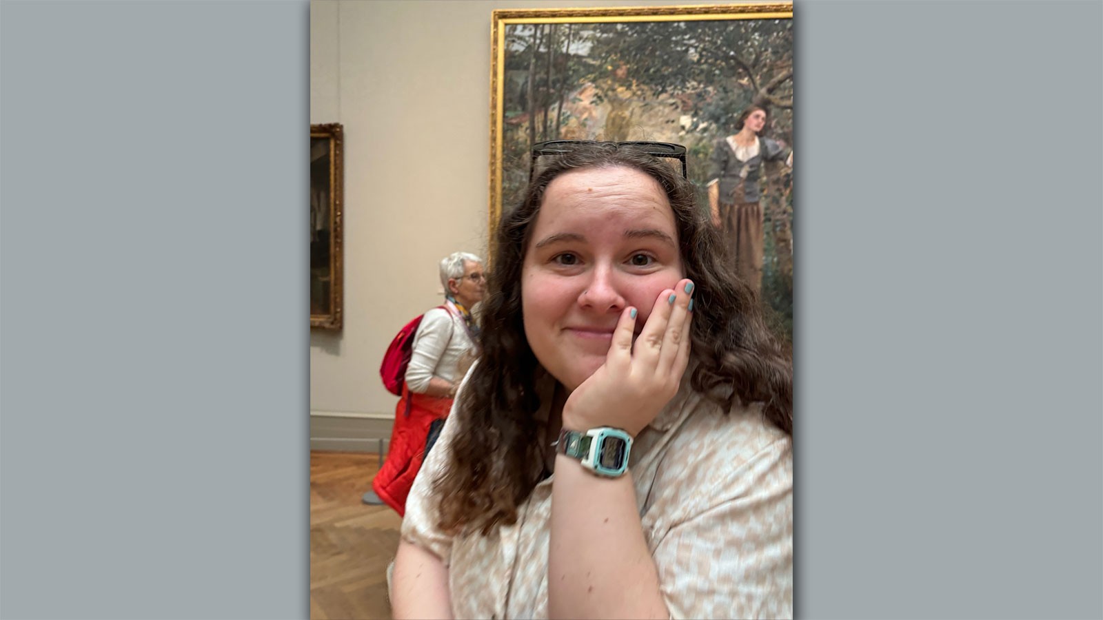Elizabeth Leishman posing in front of a painting at a museum.