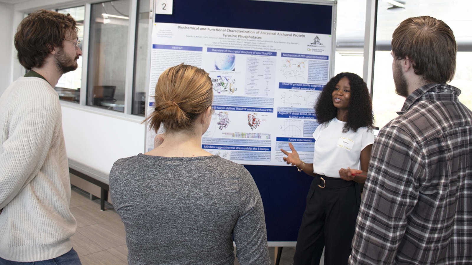 Scholars at a research poster.