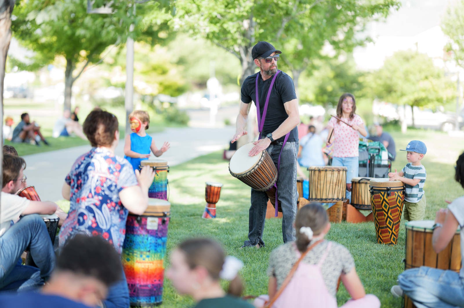 People playing drums in a park.